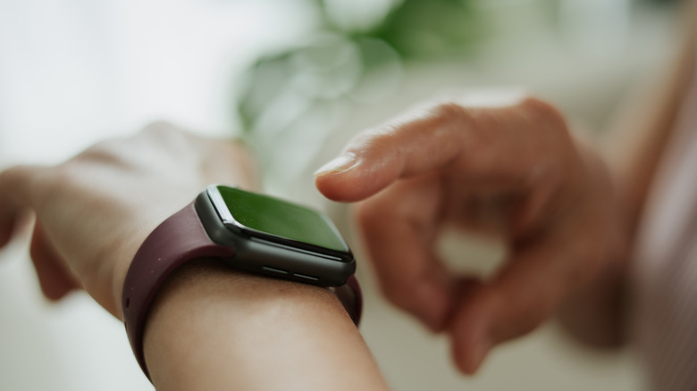 Close-up hand using smartwatch