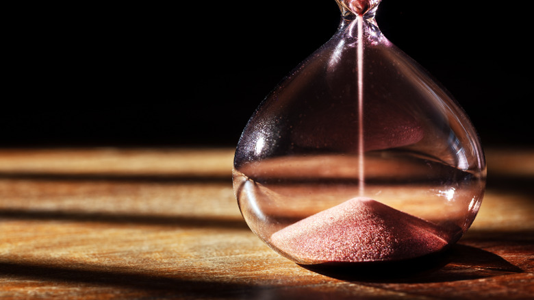 Hourglass time passing with a dark background