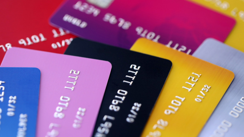 A pile of multiple credit cards of various colors