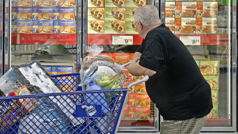 Grey-haired man shopping in the Sam's Club frozen food section
