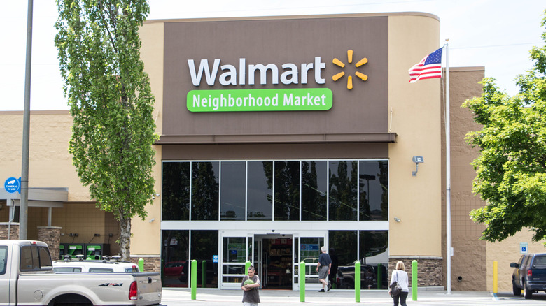 Walmart Neighborhood Market exterior with people in parking lot
