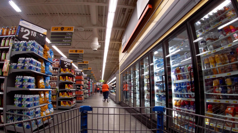Inside view of Walmart Neighborhood Market dairy case and aisles, viewed from shopping cart
