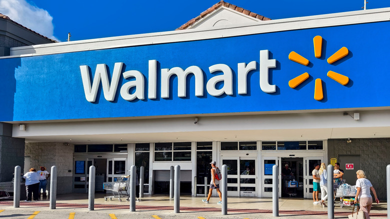 Image from the parking lot of a Walmart Supercenter with customers going inside