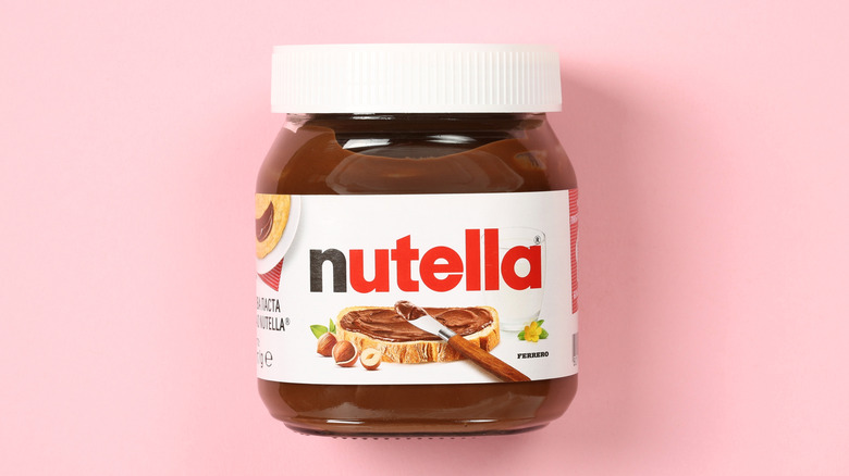 Jar of Nutella on pink background