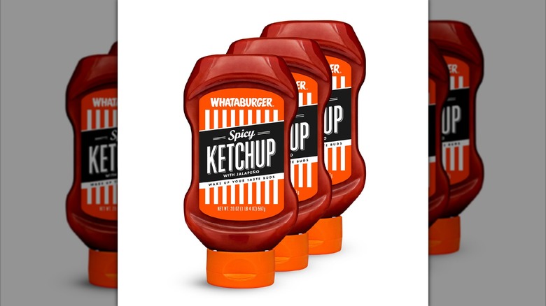 Three bottles of Whataburger Spicy Ketchup on display.