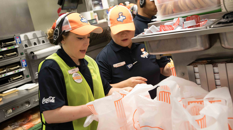 Whataburger employees managing to-go orders during rush.