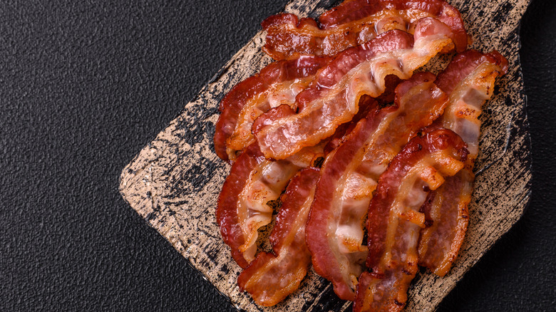 Crispy bacon on wooden board