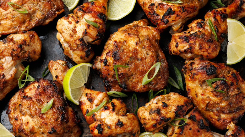 Baked jerk chicken on sheet pan with lime and scallions