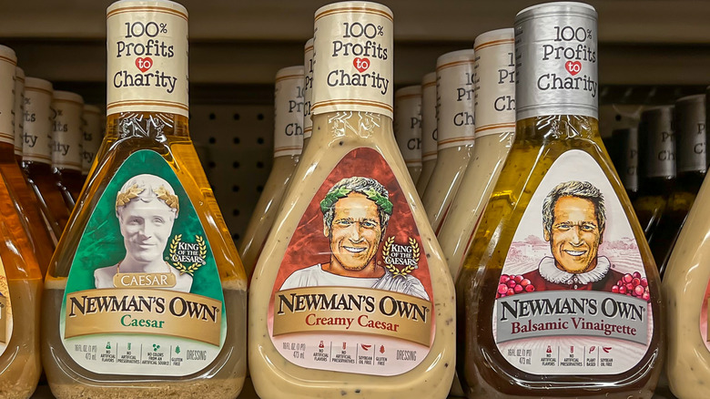 Bottles of Newman's Own salad dressing on a supermarket shelf