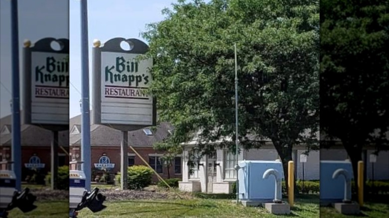 Bill Knapp's restaurant sign next to large tree