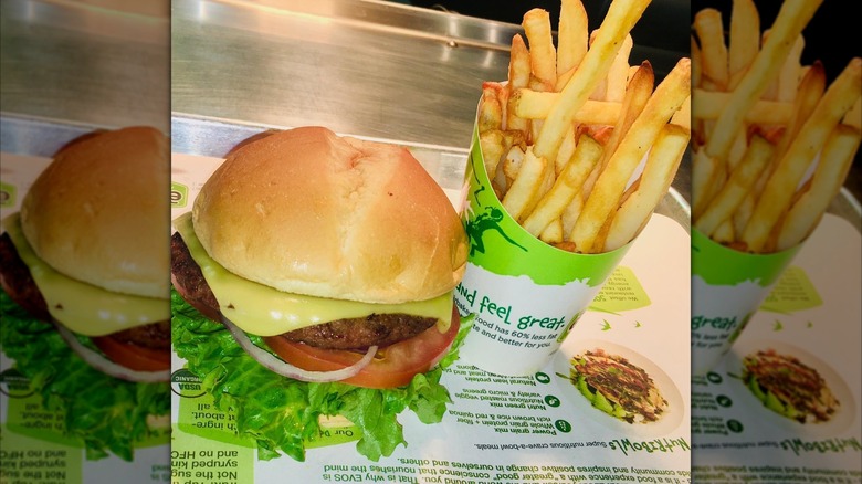 mirrored image of burger and fries from EVOS Feel Great Food on a tray