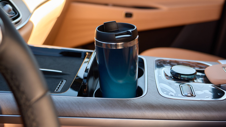 A coffee tumbler in a car cup holder