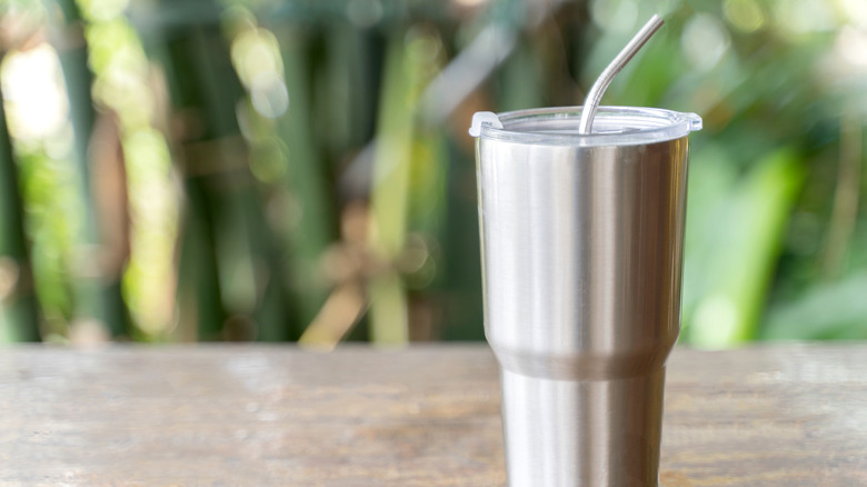 A steel coffee tumbler with straw