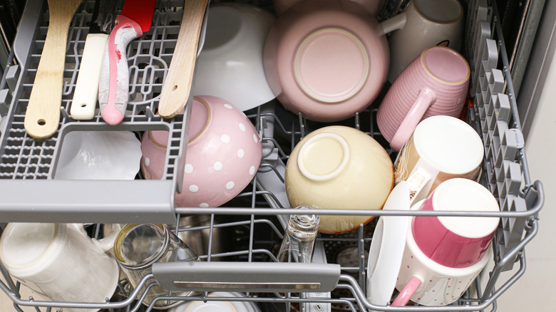A dishwasher filled with kitchen items
