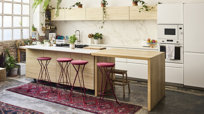 Four red stools arranged next to kitchen island