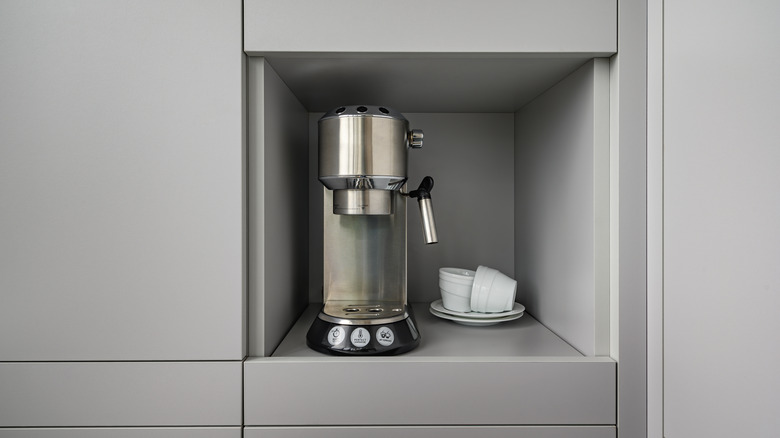 Modern gray kitchen with coffee maker in enclosed corner