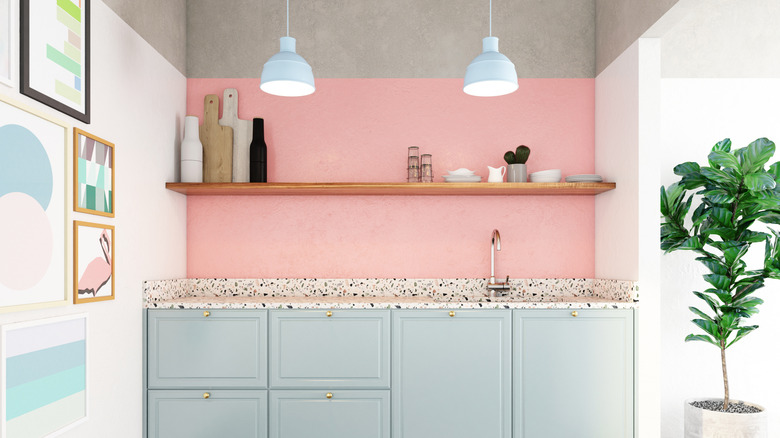 1980s-style kitchen with pink walls, blue cabinets and terrazzo countertops
