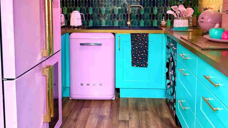 Bright kitchen with neon cabinets and pink vintage refrigerator