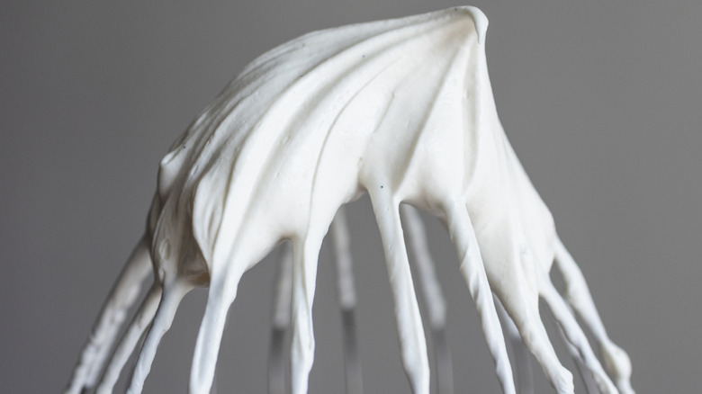 Close up of whipped cream peak on a large whisk