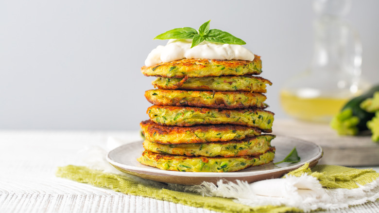 Savory pancakes topped with sour cream and herbs
