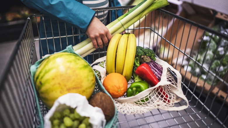 Person filling their cart with produce