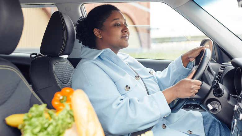 Woman driving back from grocery store