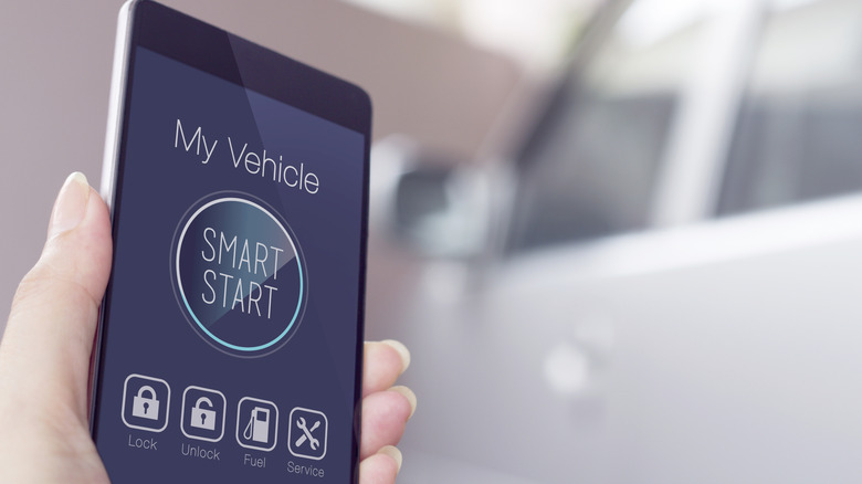 Smart start car app on cellphone with car in background