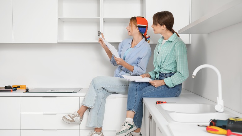 Two women reading an instruction manual