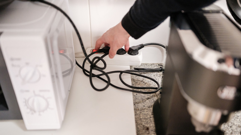 Person unplugging kitchen appliances