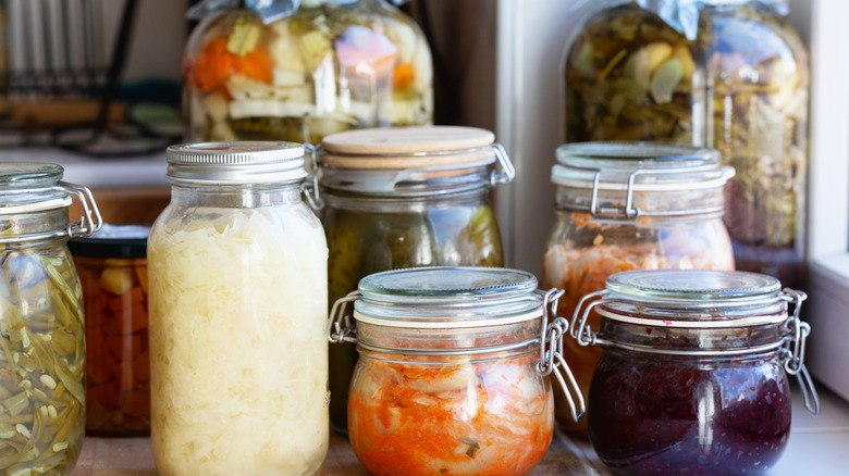 Various jars of fermented foods like kimchi and sauerkraut