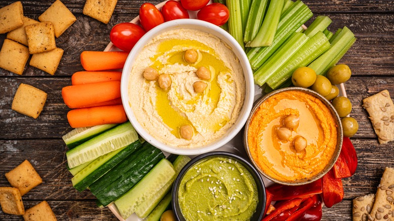 Colorful veggie snack plate with dips