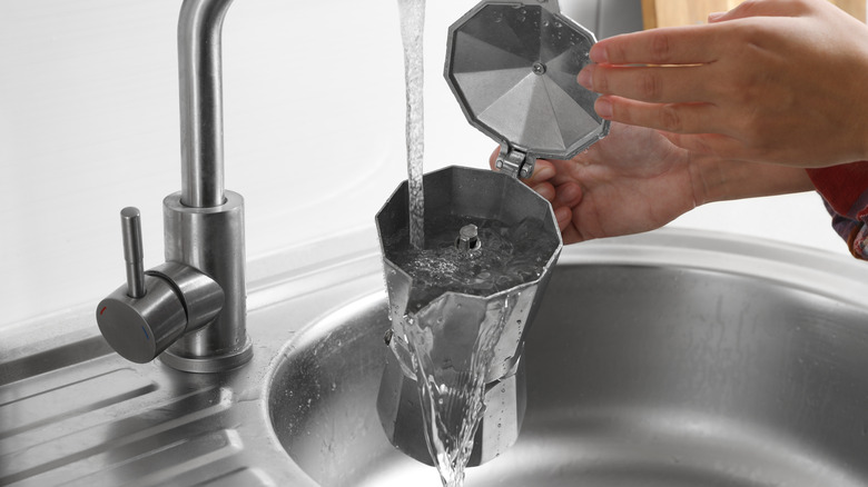 Washing Moka pot with running water