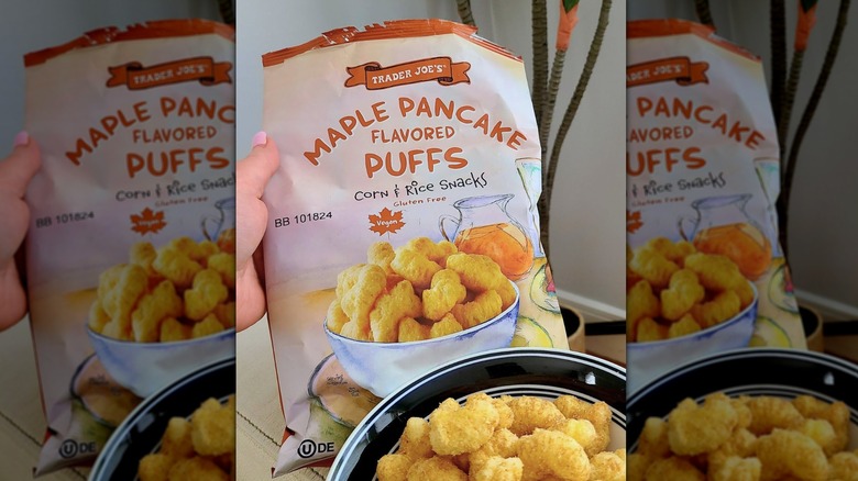 Hand holding bag of Trader Joe's Maple Pancake Flavored Puffs