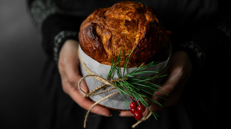 Someone holding a festively wrapped panettone