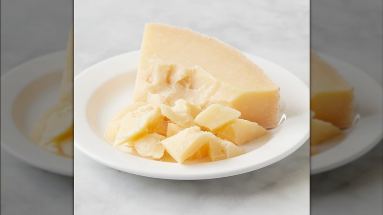 Large triangle of piave vecchio on plate, slightly crumbled