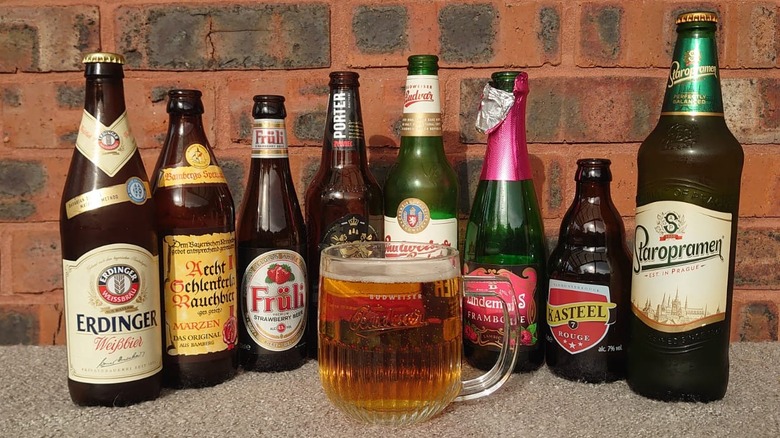 A selection of underrated beers highlighted in the article behind a full glass of beer