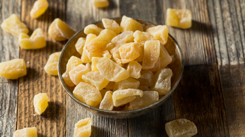 Chunks of candied ginger spilling from bowl