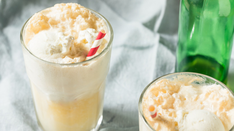 Two glasses of ginger ale ice cream floats with straws