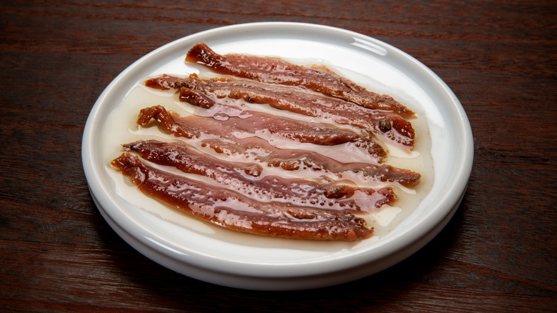 Canned anchovy fillets on plate