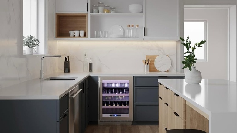 Elegant kitchen with gray lower cabinets and a small beverage fridge