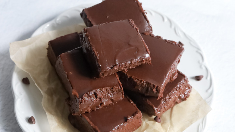 Dairy-free chocolate fudge squares piled on plate