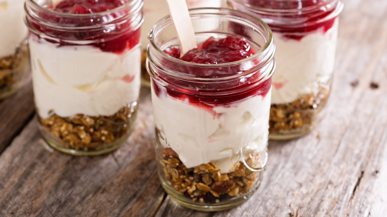 Three cranberry breakfast parfaits in serving glasses
