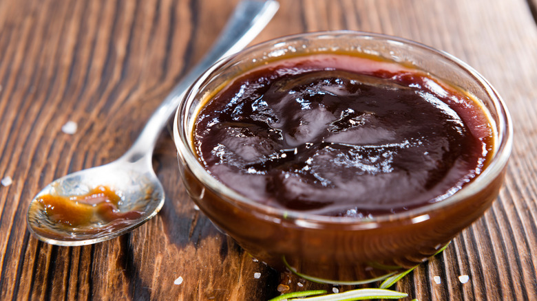 Bowl of barbecue sauce next to spoon