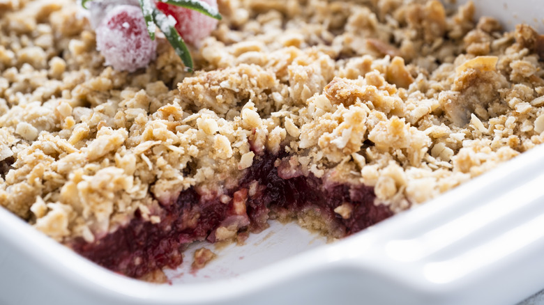 Apple and cranberry crisp in white baking dish