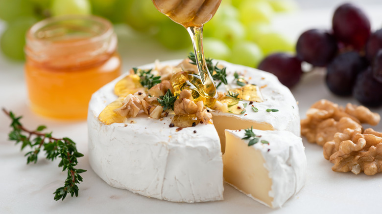 A wheel of camembert with honey and walnuts