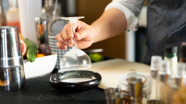 bartender rimming cocktail glass