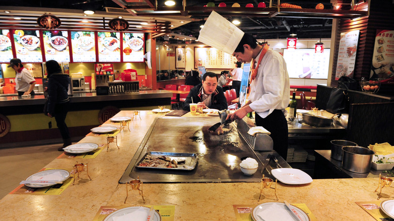 One person sitting at a hibachi grill