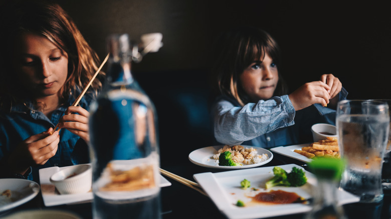 Kids enjoying the hibachi experience with bowls of food