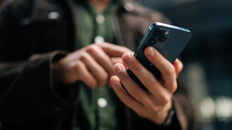 Person dialing on a cell phone