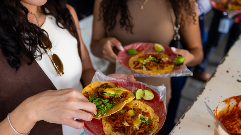 Woman eating tacos on the street in Mexico